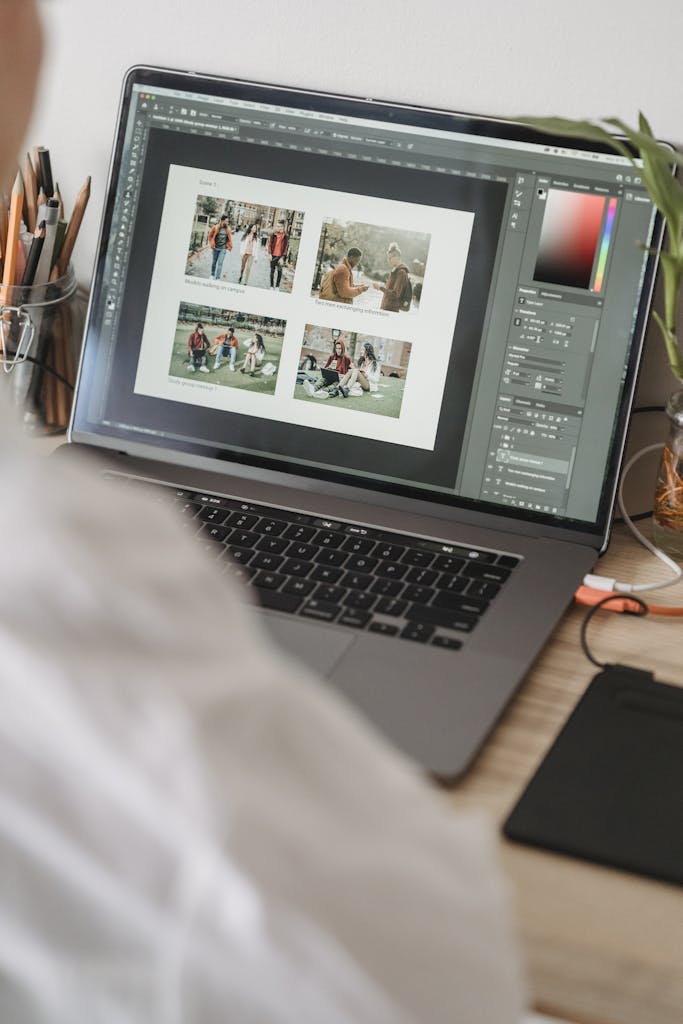 Unrecognizable person working on laptop and choosing photos